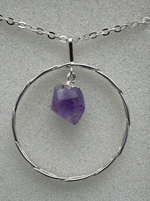 Natural Amethyst Point suspended within Silver Plated Intertwined Circle on Silver Plated Chain