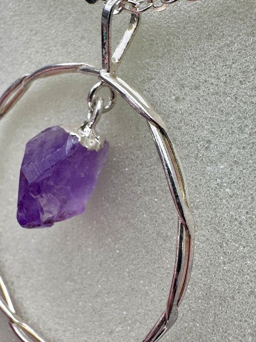 Natural Amethyst Point suspended within Silver Plated Intertwined Circle on Silver Plated Chain