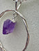 Natural Amethyst Point suspended within Silver Plated Intertwined Circle on Silver Plated Chain