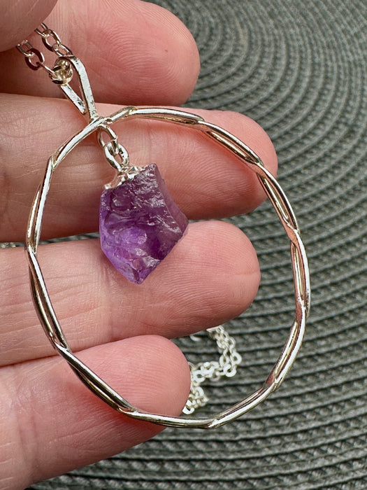 Natural Amethyst Point suspended within Silver Plated Intertwined Circle on Silver Plated Chain